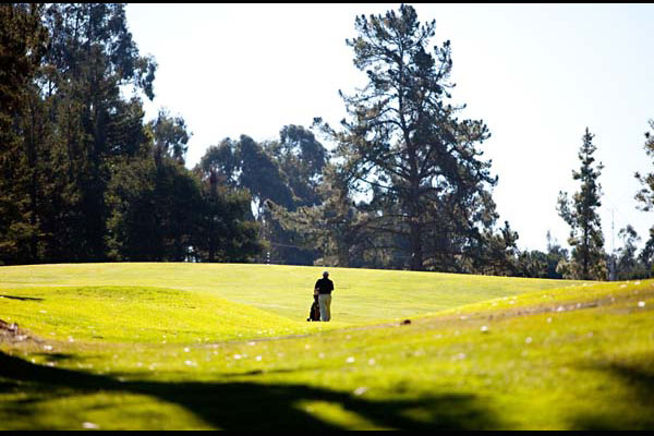 golfer holding his golf bag