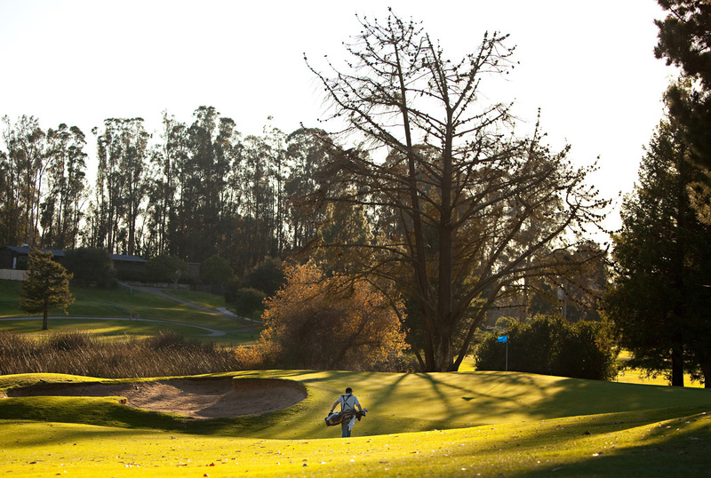 player on the fairway walking towards the green