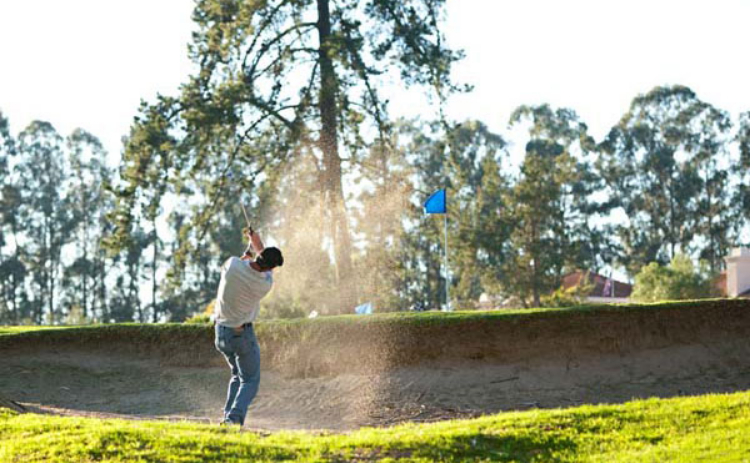 view of golfer in bunker